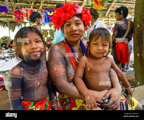 Mother And Her Two Children Posing In The Embera Indigenous Village In