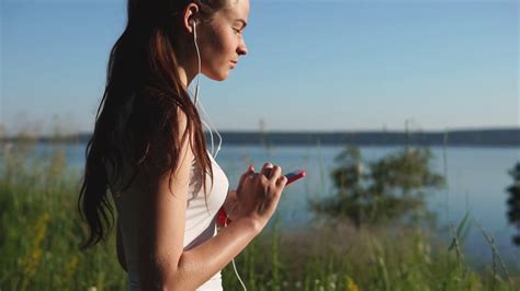 Young Woman Using Her Smartphone Enjoying The Nature Female Listen To