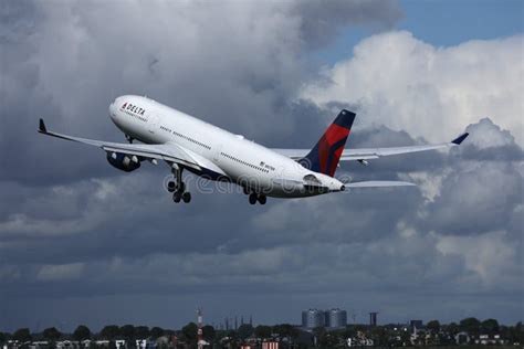 Delta Airlines Plane Taking Off From Runway Clouds In The Sky