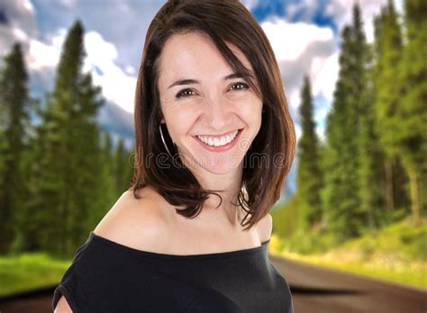 A Portrait Of An Attractive Woman Smiling Outdoors By Green Road Summer