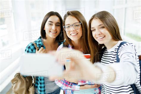Three Girls Making Selfie After Classes Stock Photo Dissolve