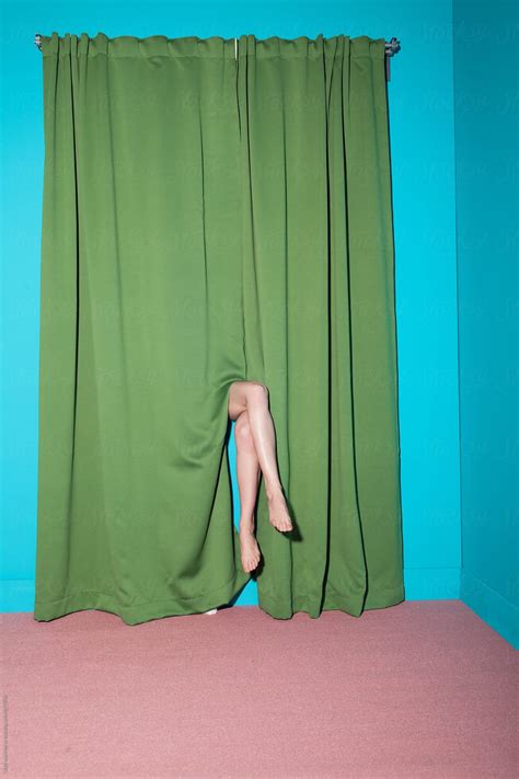 Legs Of A Lady Hiding Behind The Curtain In A Room By Stocksy Contributor Ulas Merve