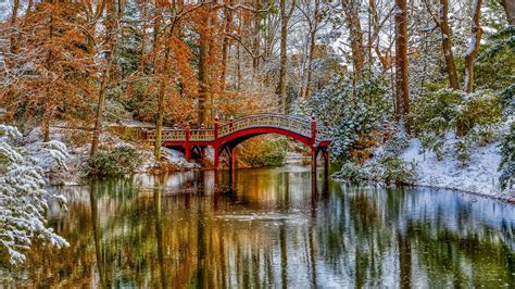 Landscape View Of Bridge Above River Surrounded By Snow Covered Autumn