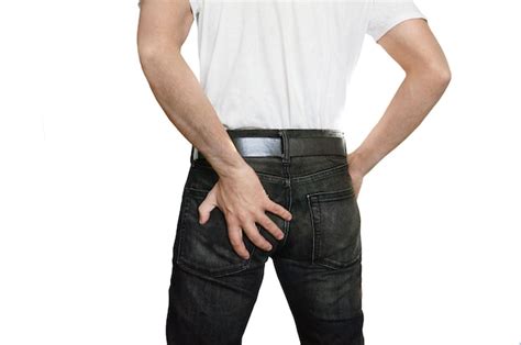 Premium Photo Man With Hemorrhoids Guy With Pain In Black Jeans Holding His Ass With His Left