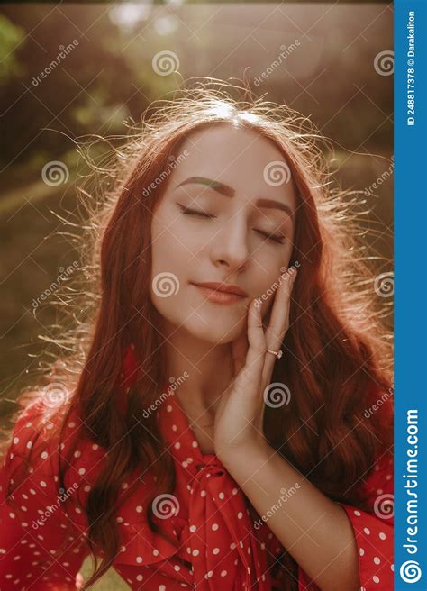 Portrait Of Pretty Redhead Woman Outdoor In Sunset Light Female Model Touching Her Face By Hand