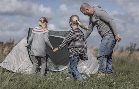 Handsome Redhead Father And Blonde Daughters Enjoying A Camping Holiday Despite The Wintry