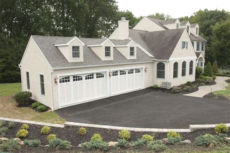 Traditional Garage With Dormer Window And Carriage House Garage Doors