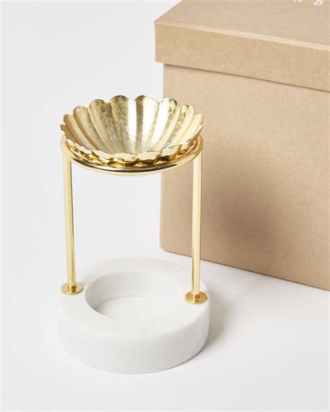Add A Few Drops Of Your Favourite Essential Oils To The Gold Toned Flower Shaped Dish And Place