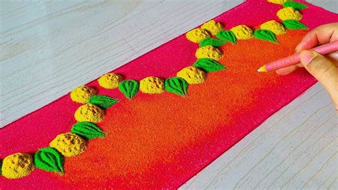 Someone Is Decorating A Table With Oranges And Green Leaves On Red
