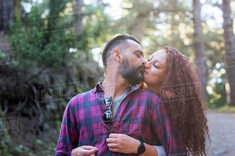 Couple Kissing By Trees Stock Photo Dissolve