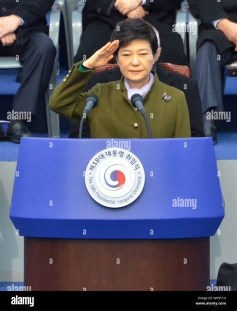 south korea s new president park geun hye salutes during the 18th presidential inauguration