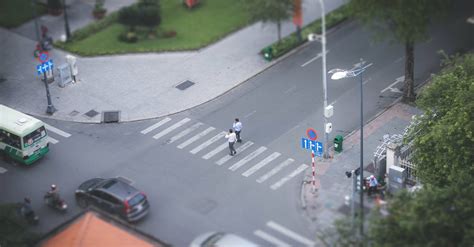 Two Person Walking On Pedestrian Lane · Free Stock Photo