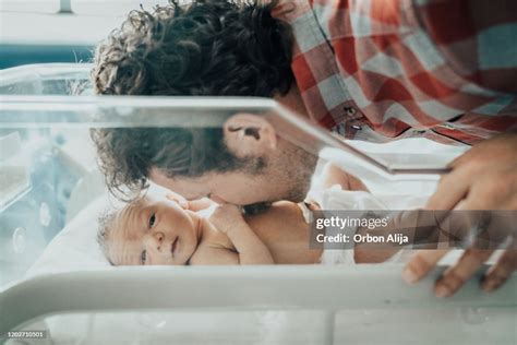 Father Kissing His Newborn Baby High Res Stock Photo Getty Images