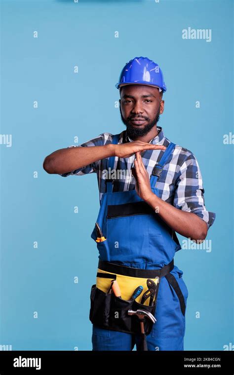 Tired Construction Worker Announcing Time Out Symbol With Hands Making