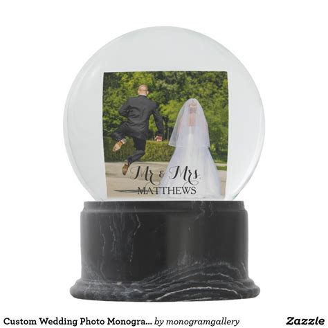 A Snow Globe With A Bride And Groom Photo In The Center On Top Of It