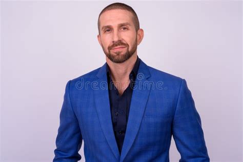 Portrait Of Handsome Bald Bearded Businessman In Suit Stock Photo