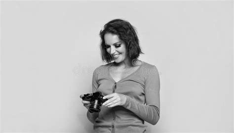 Happy Girl Photographer Looking At Camera Screen Beige Background