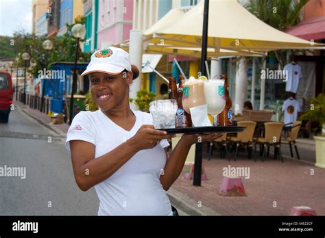 Friendly Waitress Serving Drinks At Waterfront Of Punda Willemstad Curacao Netherlands