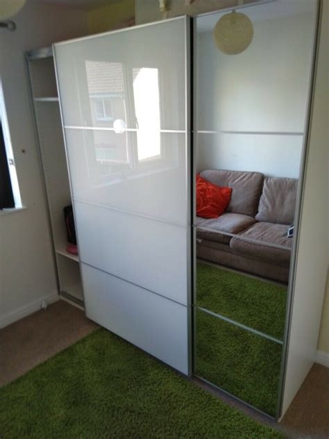 Wardrobes with sliding doors don't need free space in front of the wardrobe as they simply slide back and forth within the wardrobe's frame. IKEA PAX AULI/FARVIK Sliding wardrobe doors. 200x201cm ...
