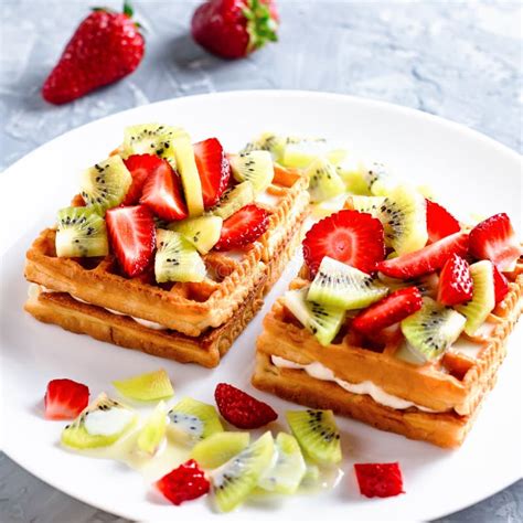 Belgian Waffles With Fruits Strawberries And Kiwi On White Plate