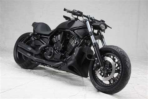A Black Motorcycle Parked On Top Of A White Floor