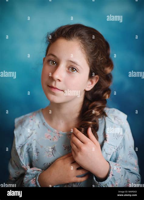 Portrait Of Little Girl In Studio On Blue Background Stock Photo Alamy