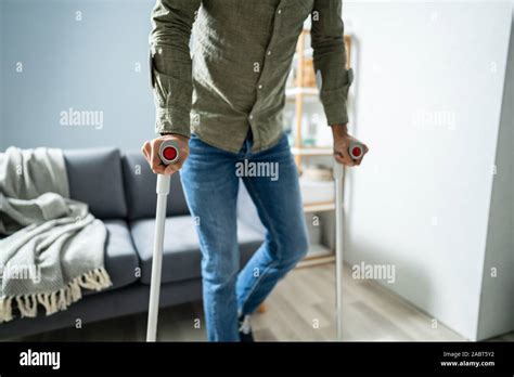 Disabled Man Using Crutches For Walking On Floor Stock Photo Alamy