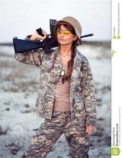 Young Female Soldier Dressed In A Camouflage With A Gun In The O Stock