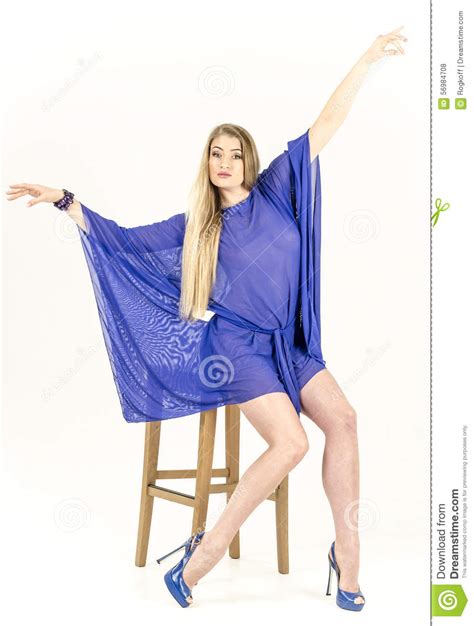 Beautiful Long Haired Blonde In A Clear Blue Tunic And Blue Shoes Stock