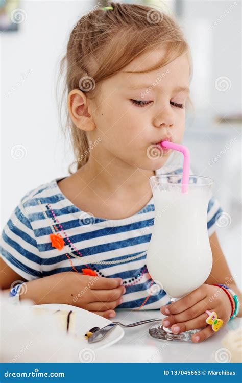 Adorable Little Girl Drinking Milkshake Royalty Free Stock Photography