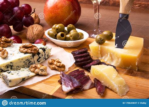 Assortment Of Cheese With Fruits Grapes Nuts Glass With Wine And