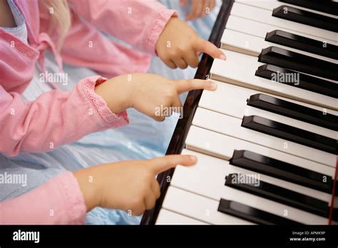 Triplets playing piano (focus on hands Stock Photo - Alamy
