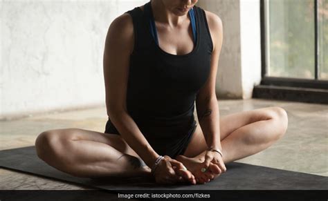 Sporty beautiful blond young woman in sportswear working out indoors, doing butterfly pose with closed eyes, sitting. International Yoga Day: These Are The Most Effective Yoga Asanas For Relief From PCOD