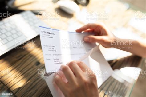 Businessperson Opening Envelope With Paycheck Stock Photo Download
