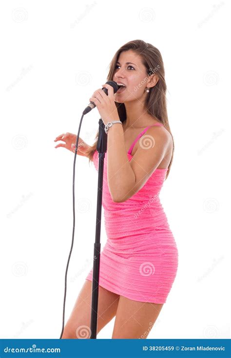Beautiful Girl Holding Microphone And Singing In A Dress Stock Image