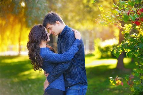 Portrait Of A Beautiful Girl And A Guy Kissing In The Sun Stock Image