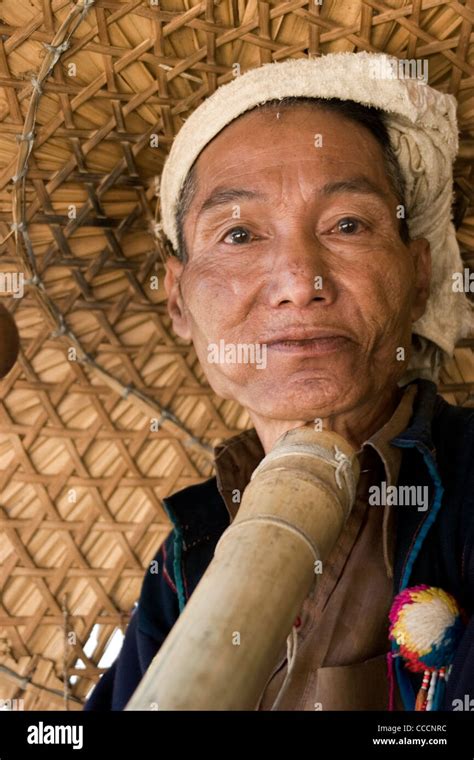 A Yao Ethnic Hill Tribe Man Is Smoking A Pipe And Wearing A Big Straw Hat In Chiang Rai Province