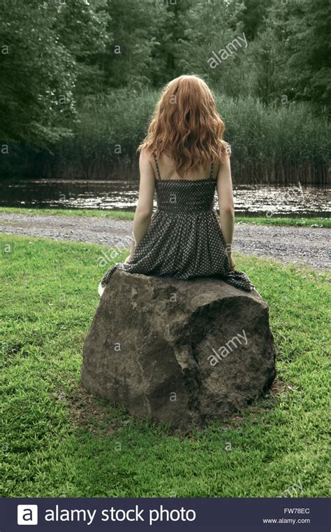 Latest 8 uploaded image attachments. Back view of a young woman in polka dot dress sitting on a rock Stock Photo - Alamy