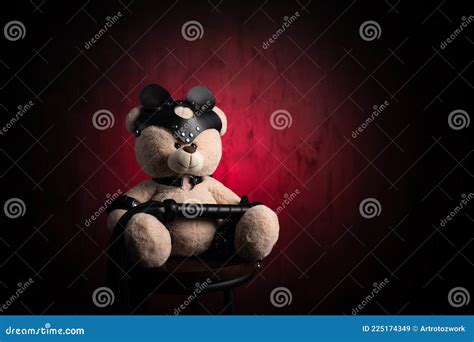 A Toy Teddy Bear With A Whip Dressed In Leather Belts And A Mask An Accessory For Bdsm Games