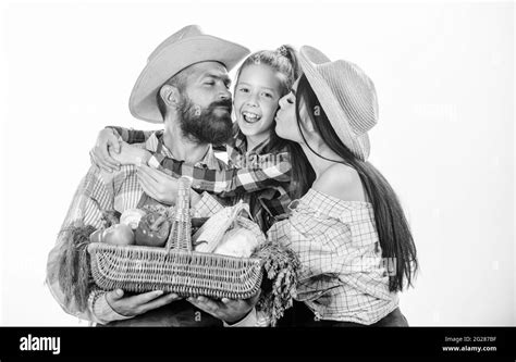 Family farmers hug hold basket fall harvest. Family gardeners basket