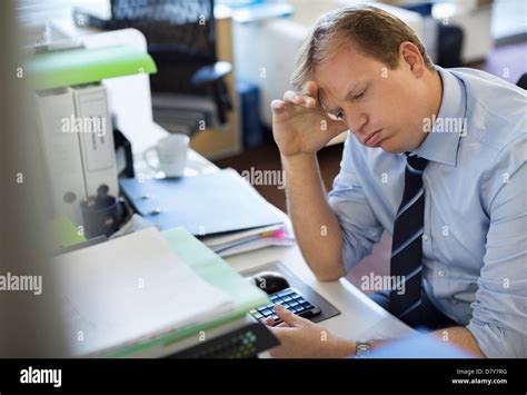 Businessman Sighing At Desk Stock Photo Alamy