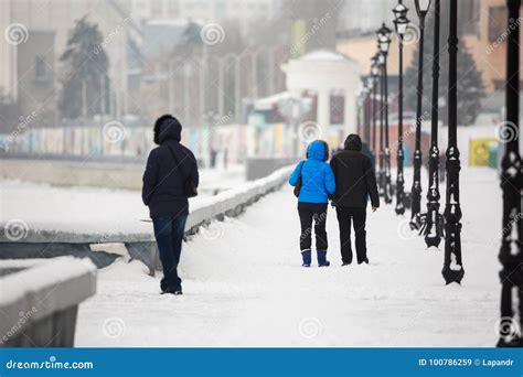 A Date In The Winter On The Waterfront People Walk In The Snow On The