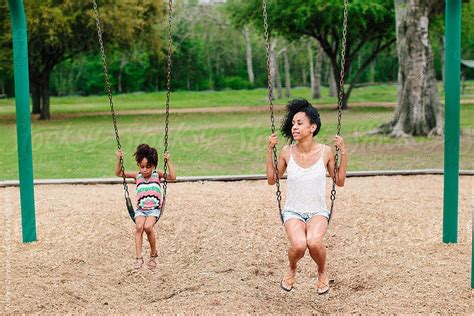 Mother And Daughter Having Fun On Playground Swing By Stocksy Contributor Kristen Curette