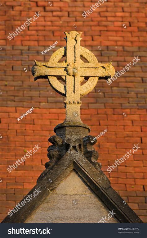 Anglican Cross On A Church Roof With A Background Of Red Clay Roof