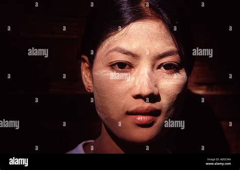 A Beautiful Young Burmese Women Wears Tanaka On Her Face Stock Photo