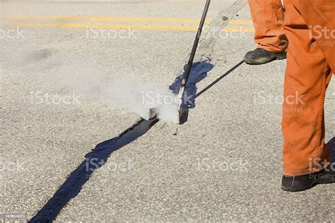 Hot Tar Asphalt Road Crack Repair Stock Photo Download Image Now