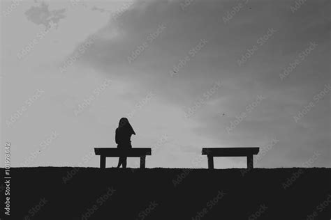 The Silhouette Of Woman Sitting Alone With Grey Sky Concept Of Lonely