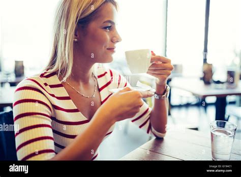 Beautiful Woman Drinking Coffee In A Nice Restaurant Stock Photo Alamy