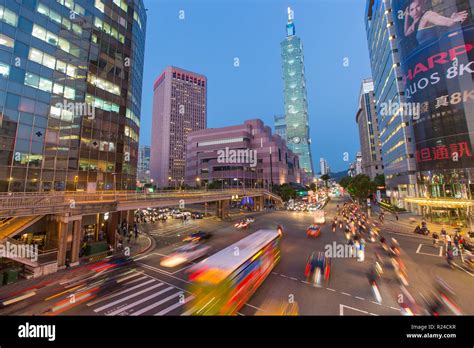 Traffic In Front Of Taipei 101 At A Busy Downtown Intersection In The