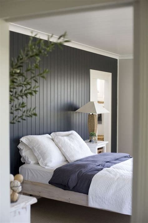 The dark painted wood paneling feature wall makes quite a statement in